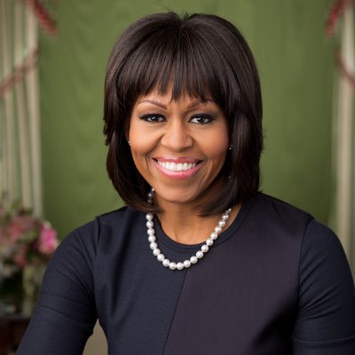 Michelle Obama, smiling, in an official White House portrait taken in the Green Room, February 12, 2013. Cropped.