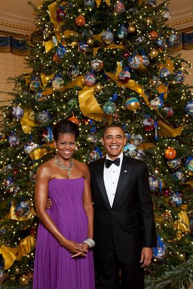 Verified real photograph: Barack Obama and Michelle Obama posing in front of the official White House Christmas tree in the Blue Room, December 6, 2009.